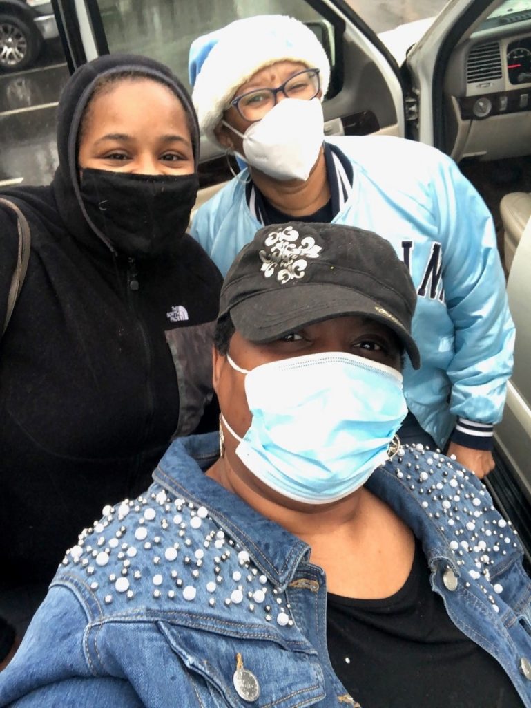 Selfie of three parents of the Burton Parent Mentor Partnership smiling with masks on