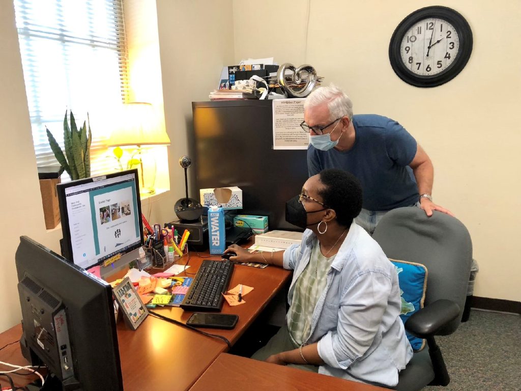 Reed-Bandele (left) and Jarmul (right) work on the center’s communications.