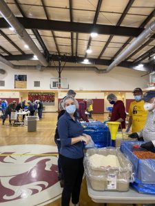 Jessica Voss helps scoop rice into food packs