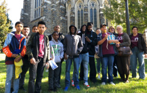 A group of middle school students pose in front of Duke chapel