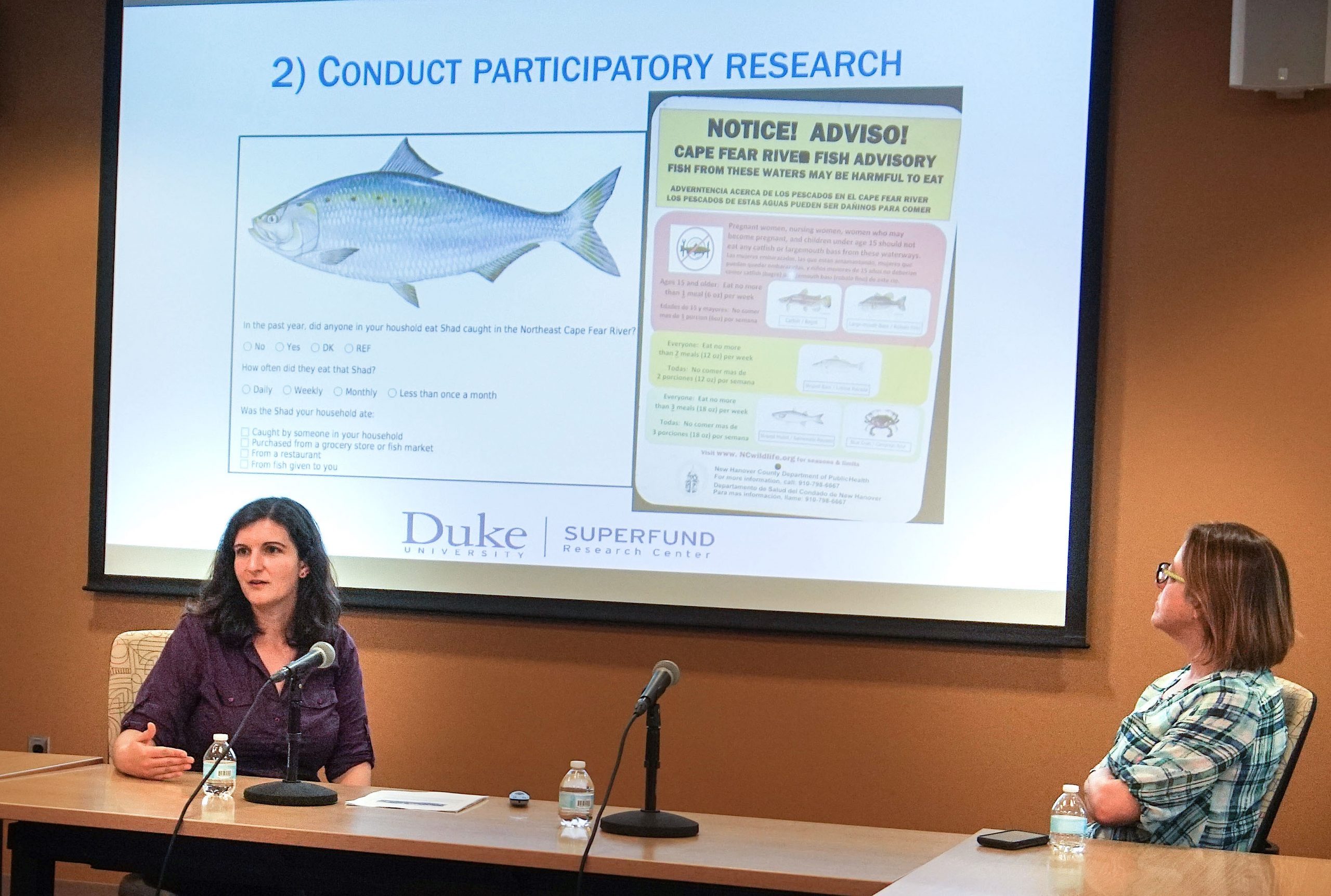 Duke faculty giving a power point presentation at a talk